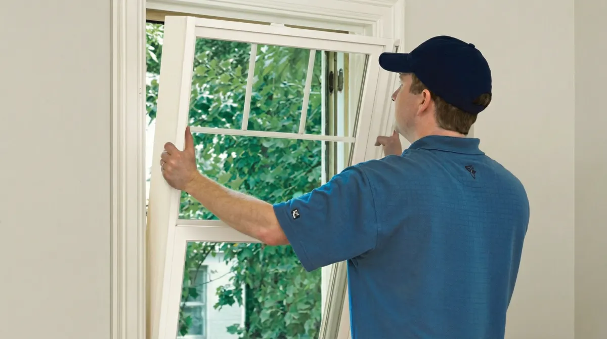 Professional contractors performing a residential window insulation and replacement service in Tuscaloosa, AL